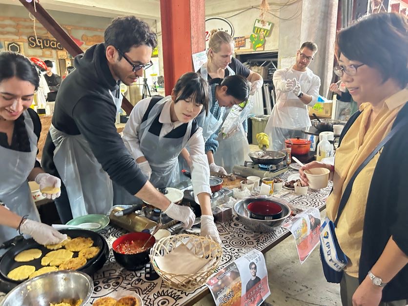International participants and local residents cooking side by side